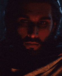 a man with a beard is looking at the camera