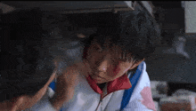 a boy with blood on his face is being helped by a man