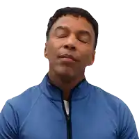 a man with his eyes closed wearing a blue shirt