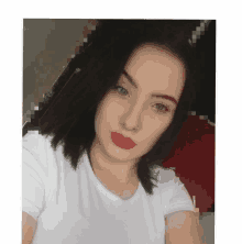 a woman wearing a white shirt and red lipstick