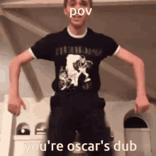 a man wearing a black shirt that says " you 're oscar 's dub " on it