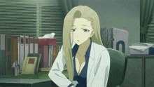a woman in a lab coat sits at a desk with a box of tissues in front of her
