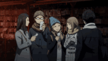 a man and a woman are standing next to each other and the man is wearing a scarf