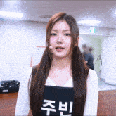 a girl wearing a black apron with chinese writing on it