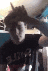 a young man wearing a black shirt that says elite on it