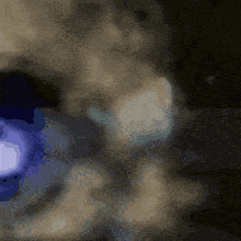 a blurred image of a person 's face with a blue circle in the center