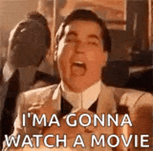 a man in a suit and tie is screaming and saying `` i 'm going to watch a movie '' .