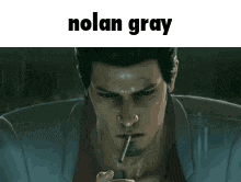 a man in a suit is smoking a cigarette with the name nolan gray written above him .