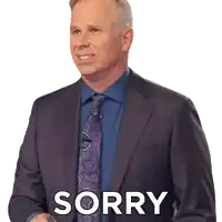 a man in a suit and tie has the word sorry written on his chest