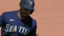 a baseball player wearing a helmet and gloves is standing on the field .
