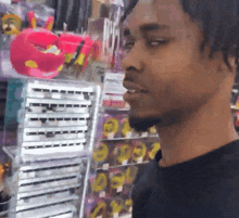 a man in a black shirt is standing in front of a store shelf with a sign that says pepsi