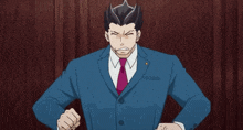a man in a suit and tie making a stop sign with his hands