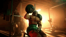 a man in a muscle suit is lifting a barbell in a gym