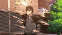 a man in a hoodie is surrounded by leaves that are flying around him