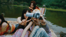 a group of girls are taking a picture of themselves with a camera and the words aespa gifs on the bottom