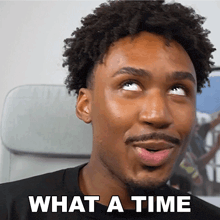 a man with curly hair and a beard is making a funny face and says what a time