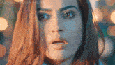 a close up of a woman 's face with a blurred background
