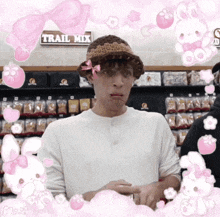 a man wearing a hat with a pink bow is in front of a sign that says trail mix