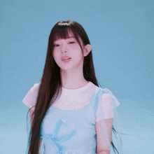 a girl with long hair and bangs is wearing a white shirt and overalls