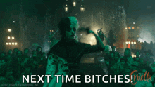 a woman in a black and white dress is dancing in front of a crowd of people and says `` next time bitches '' .