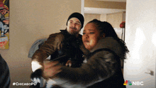 a man and a woman are fighting in a room with #chicagopd written in the corner