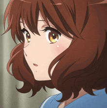 a close up of a girl 's face with a blue shirt on