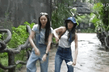 two women are dancing together in a park .