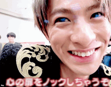 a close up of a man 's face with japanese writing on the bottom right