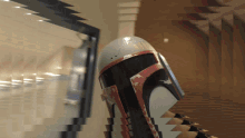 a boba fett helmet is displayed in a room with a blurry background