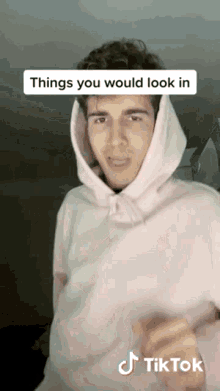 a man wearing a pink hoodie with the words things you would look in written above him