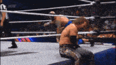 two wrestlers in a wrestling ring with aew written on the screen