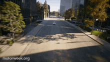 a car is driving down an empty street with motorweek.org in the corner