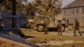 a group of people standing in front of a military truck