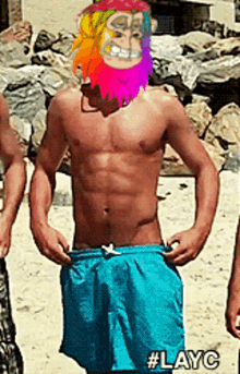 a shirtless man wearing blue shorts has a colorful monkey on his face