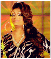 a woman wearing a zebra print top and hoop earrings looks at the camera