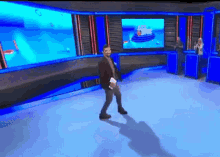 a man in a suit is dancing in front of a screen that says rtp