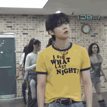 a man wearing a yellow t-shirt that says i did what last night