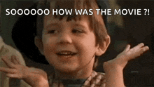 a little boy is making a funny face with his hands in the air .