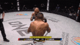 two men are fighting in a ring that says one on the ground