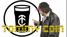a man in a leather jacket pointing at a logo for tommy coin
