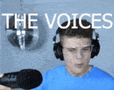 a man wearing headphones and glasses is holding a microphone with the words " the voices " behind him