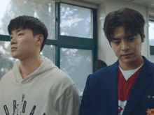 two young men standing next to each other with one wearing a white hoodie that says jordan