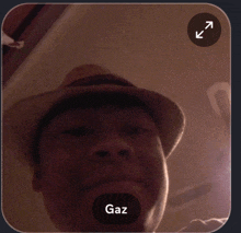 a man wearing a hat has gaz written in the corner of his face