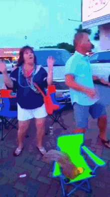 a man and a woman are dancing in a parking lot in front of a store that says union mart