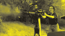 a man with glasses is holding a gun with a sticker on it that says ' x ' on it