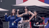 a group of young women are dancing in front of a tent and the words cheer up are visible