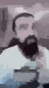 a blurry picture of a man with a beard and sunglasses .