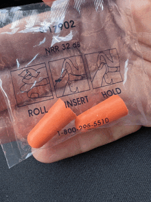 a pair of orange ear plugs are in a plastic bag