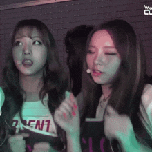 two girls standing next to each other with one wearing a shirt that says " rent "