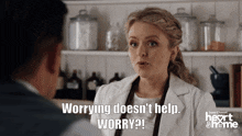 a woman in a lab coat is talking to a man and says worrying doesn 't help worry
